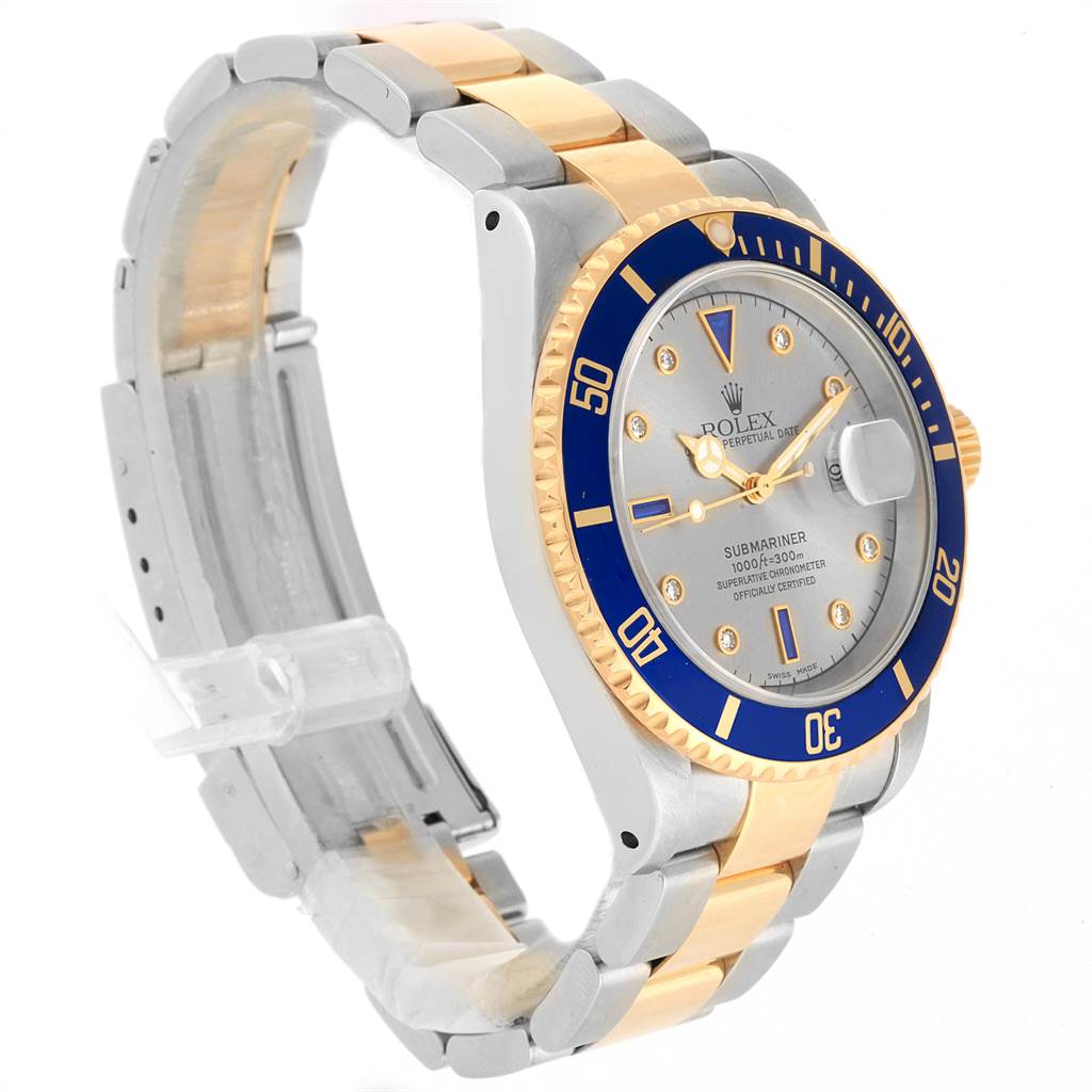 The image shows a Rolex Submariner 16613 Men's Steel and Gold (two tone) Grey Dial 16613 Men's Steel and Gold (two tone) Grey Dial watch at a three-quarter angle, highlighting its dial, bezel, and bracelet.