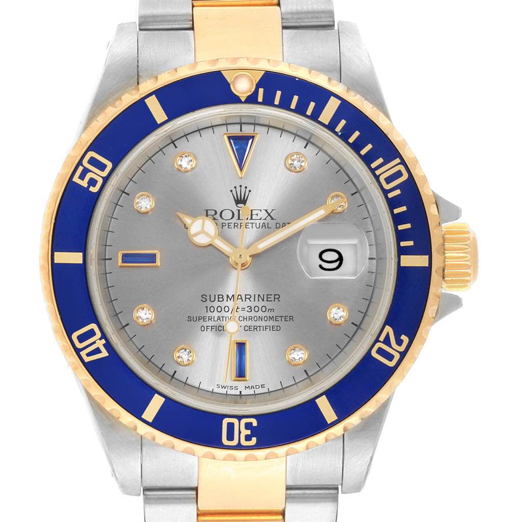 The image shows a front view of a Rolex Submariner 16613 Men's Steel and Gold (two tone) Grey Dial 16613 Men's Steel and Gold (two tone) Grey Dial watch featuring a blue and gold bezel, silver dial, and date display.