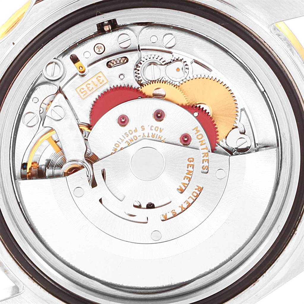 This image shows a close-up of the movement inside a Rolex Submariner 16613 Men's Steel and Gold (two tone) Grey Dial 16613 Men's Steel and Gold (two tone) Grey Dial watch, highlighting the gears and internal mechanics.