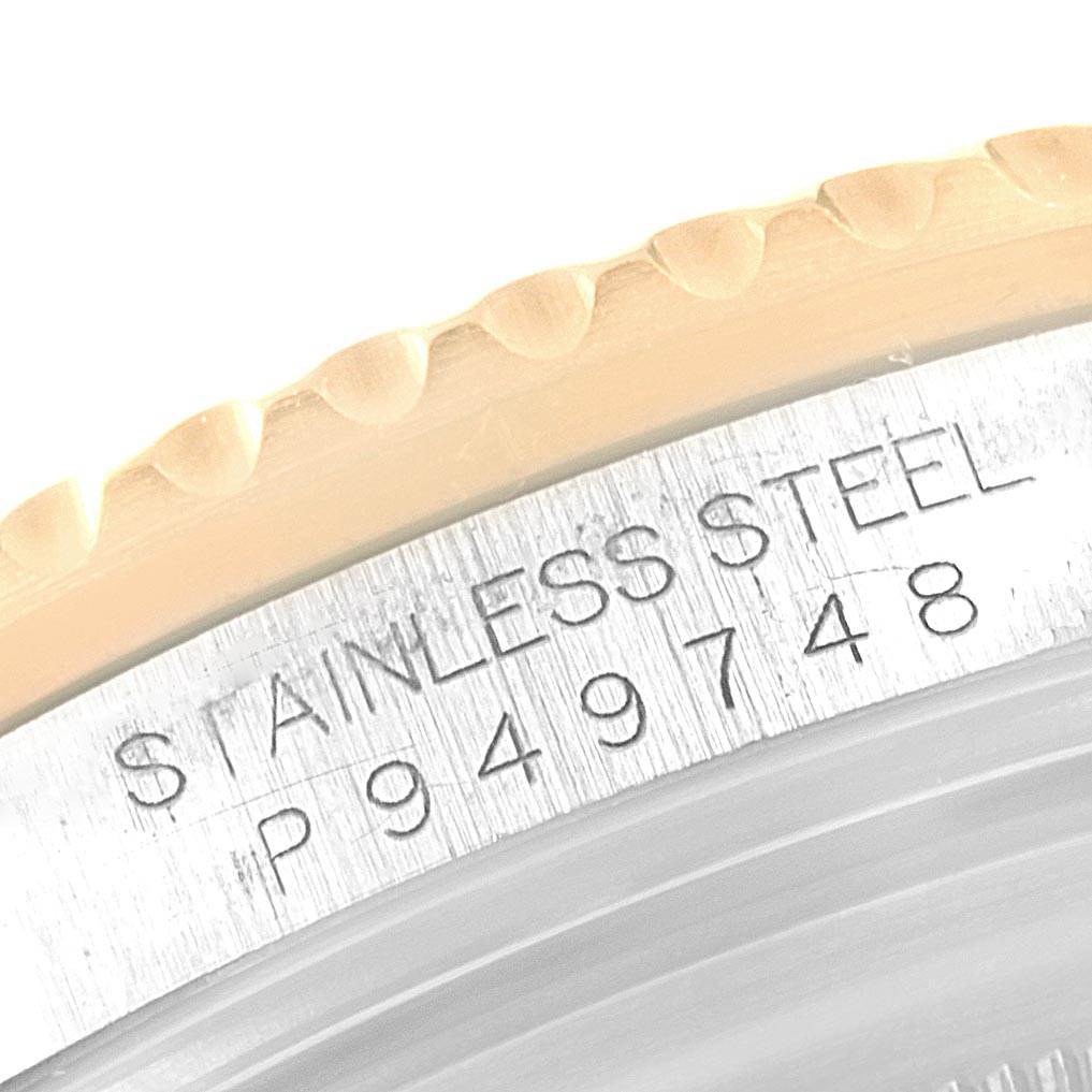 This close-up shot of the Rolex Submariner 16613 Men's Steel and Gold (two tone) Grey Dial 16613 Men's Steel and Gold (two tone) Grey Dial watch shows the stainless steel etched with the model number.