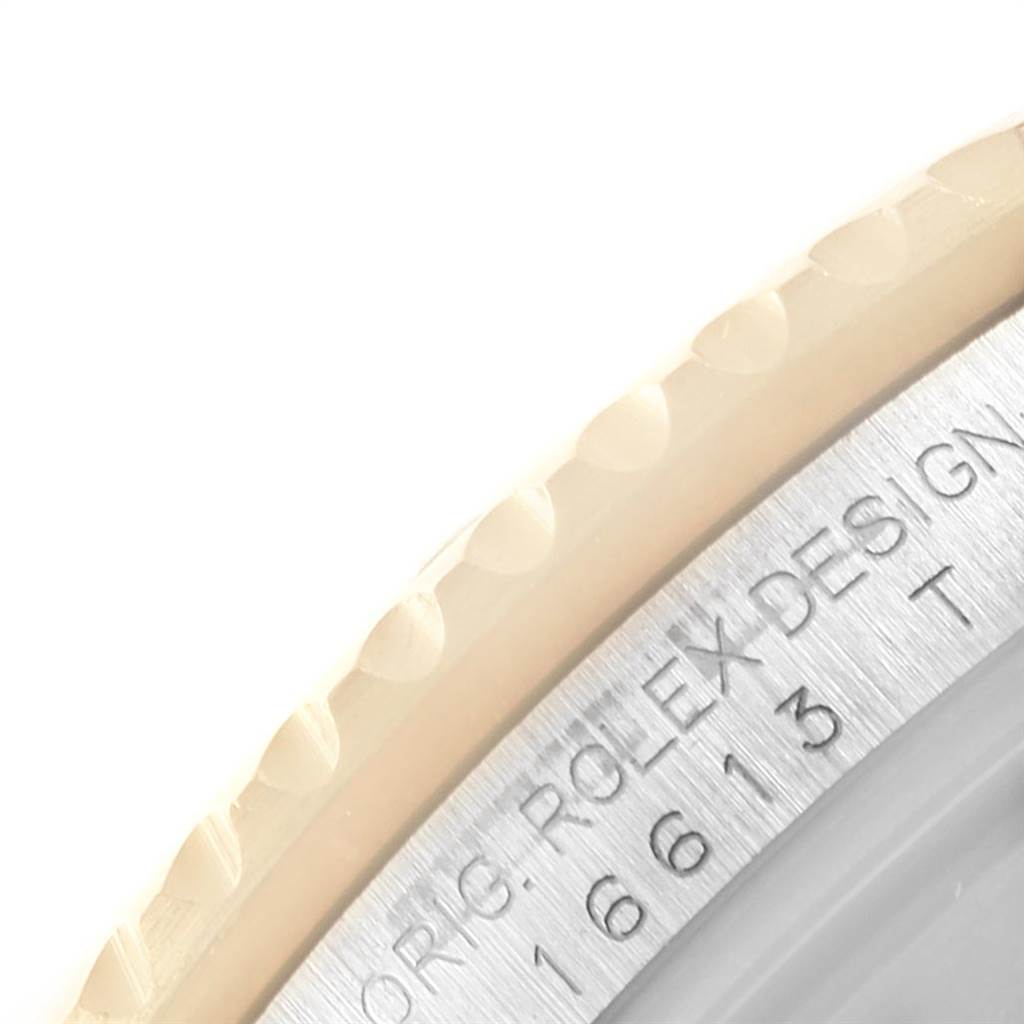 The image shows a detailed close-up of a portion of the bezel and the engraved case of a Rolex Submariner 16613 Men's Steel and Gold (two tone) Blue Dial 16613 Men's Steel and Gold (two tone) Blue Dial watch.