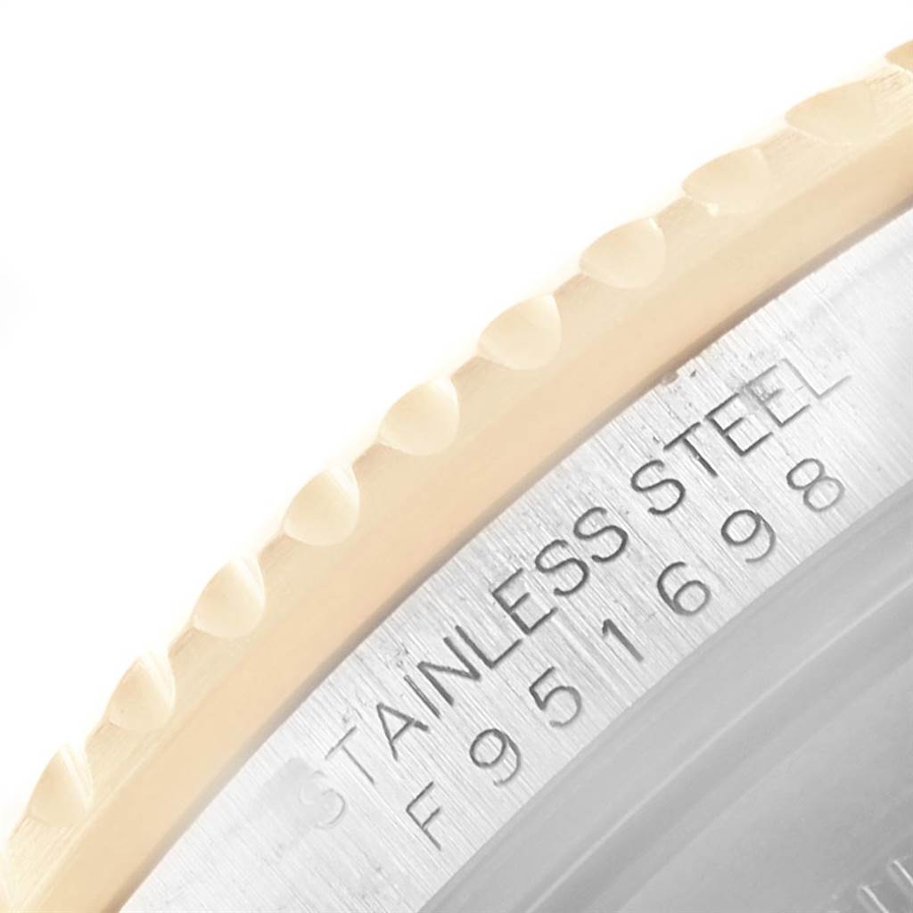 The image shows a close-up of the stainless steel outer edge and bezel of the Rolex Submariner 16613 Men's Steel and Gold (two tone) Blue Dial 16613 Men's Steel and Gold (two tone) Blue Dial.