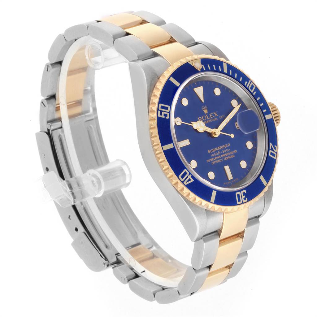 The image shows a Rolex Submariner 16613 Men's Steel and Gold (two tone) Blue Dial 16613 Men's Steel and Gold (two tone) Blue Dial watch at a three-quarter angle, highlighting the blue dial, bezel, and two-tone bracelet.