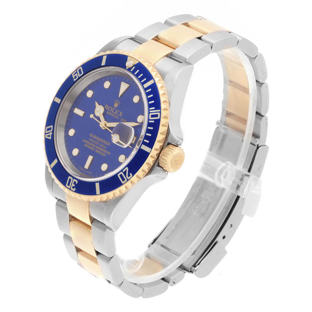 The Rolex Submariner 16613 Men's Steel and Gold (two tone) Blue Dial 16613 Men's Steel and Gold (two tone) Blue Dial watch is shown at a tilted angle highlighting the blue dial, bezel, gold crown, and two-tone bracelet.