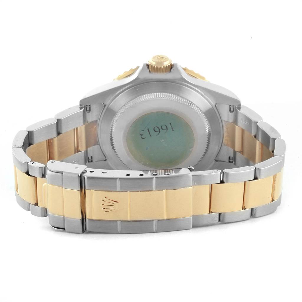 The image shows the back view of a Rolex Submariner 16613 Men's Steel and Gold (two tone) Blue Dial 16613 Men's Steel and Gold (two tone) Blue Dial watch, highlighting the case back, bracelet, and clasp.