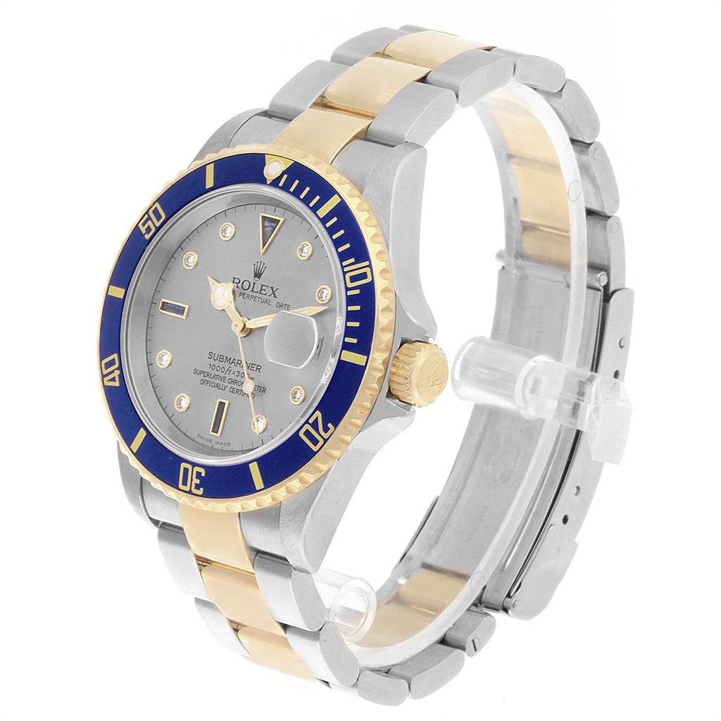 This Rolex Submariner 16613 Men's Steel and Gold (two tone) Grey Dial 16613 Men's Steel and Gold (two tone) Grey Dial watch is shown in a three-quarter angle, highlighting the face, bezel, crown, and two-tone bracelet.