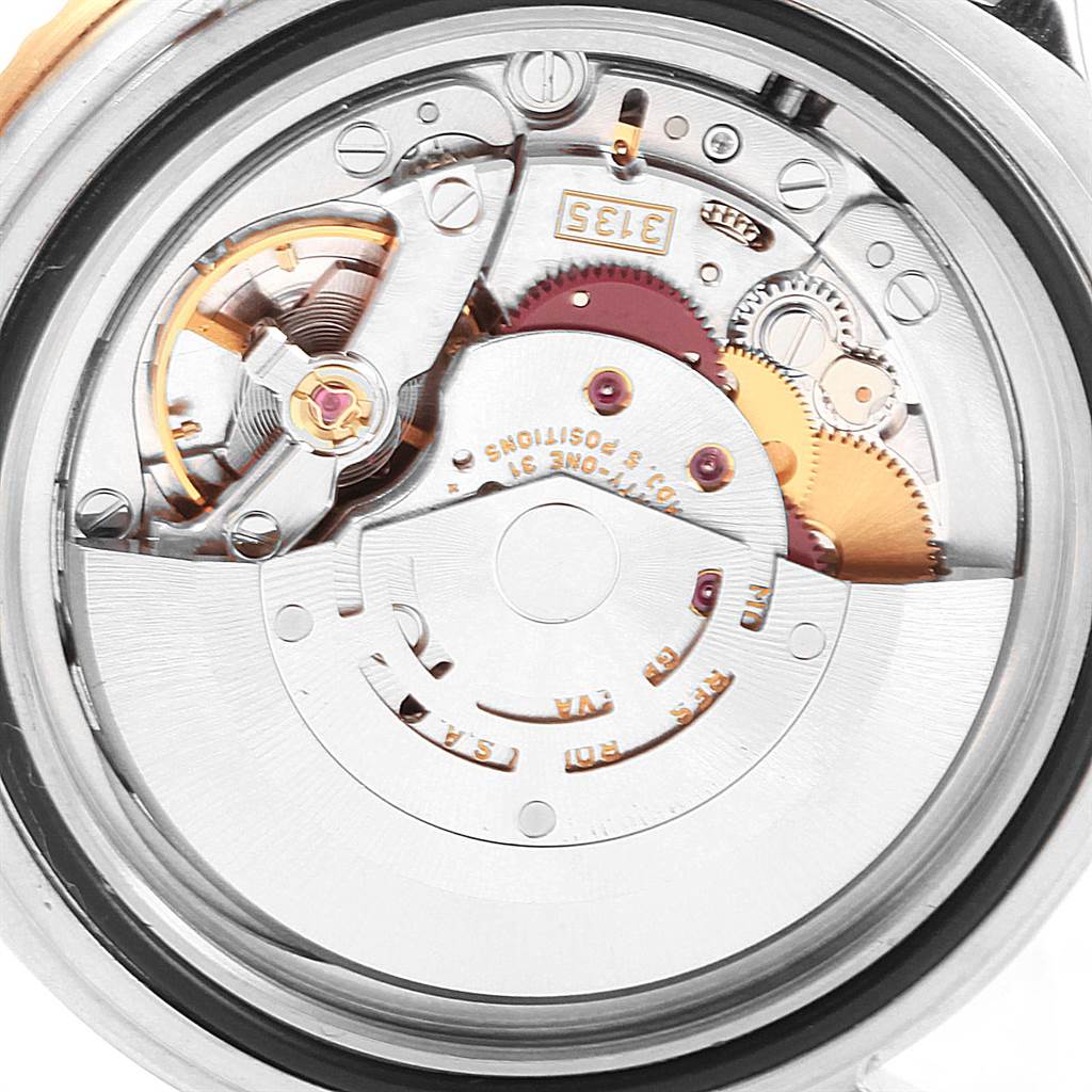 The image shows a detailed, close-up view of the internal movement parts of a Rolex Submariner 16613 Men's Steel and Gold (two tone) Grey Dial 16613 Men's Steel and Gold (two tone) Grey Dial watch.