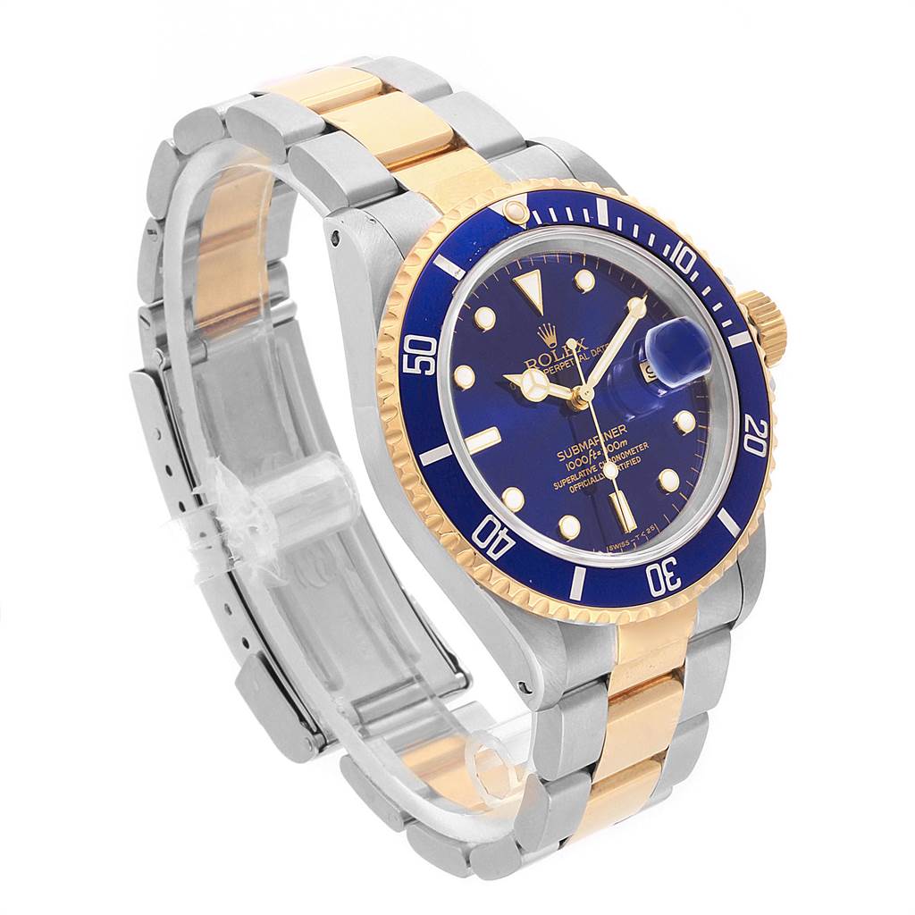 This Rolex Submariner 16613 Men's Steel and Gold (two tone) Blue Dial 16613 Men's Steel and Gold (two tone) Blue Dial model is shown at a three-quarter angle displaying its blue dial, gold bezel, and two-tone bracelet.