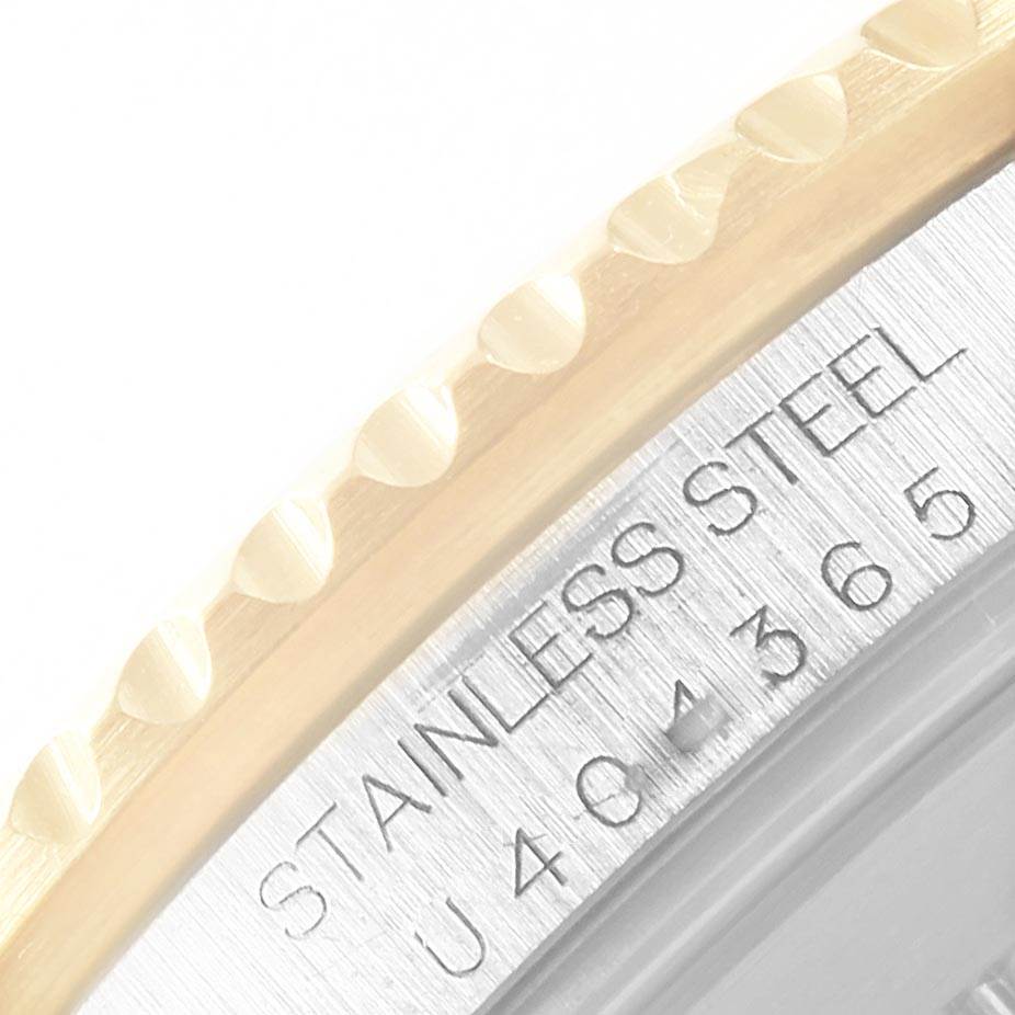 This close-up image shows part of the bezel and caseback of a Rolex Submariner 16613 Men's Steel and Gold (two tone) Blue Dial 16613 Men's Steel and Gold (two tone) Blue Dial watch, highlighting the stainless steel inscription.