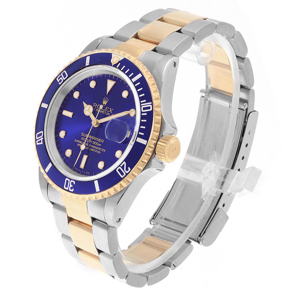 The Rolex Submariner 16613 Men's Steel and Gold (two tone) Blue Dial 16613 Men's Steel and Gold (two tone) Blue Dial watch is shown at a three-quarter angle, highlighting the blue dial, bezel, and bi-tone bracelet.