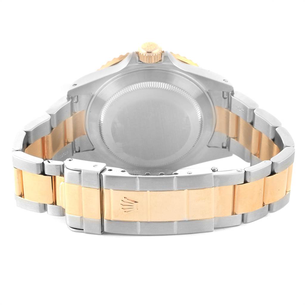 The image shows the back of a Rolex Submariner 16613 Men
s Steel and Gold (two tone) Champagne Dial 16613 Men
s Steel and Gold (two tone) Champagne Dial watch, emphasizing the bracelet and caseback from a rear angle.