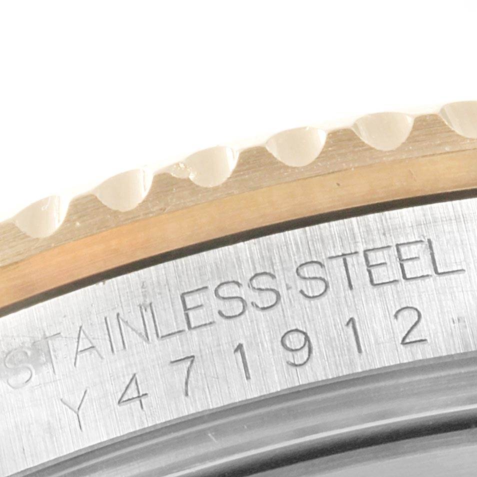 The image shows a close-up of the bezel and part of the case back of a Rolex Submariner 16613 Men
s Steel and Gold (two tone) Champagne Dial 16613 Men
s Steel and Gold (two tone) Champagne Dial, with "STAINLESS STEEL" engraved.