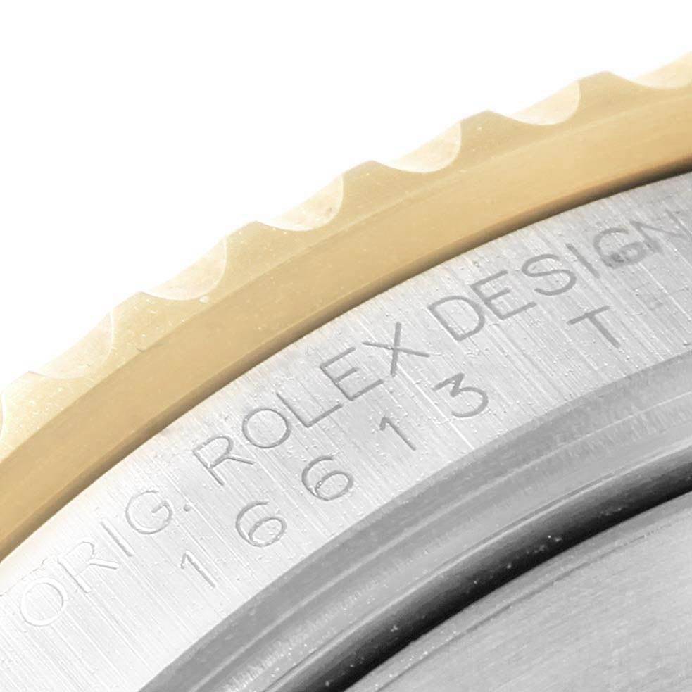 This close-up image shows part of the bezel and the engraved casing of the Rolex Submariner 16613 Men's Steel and Gold (two tone) Blue Dial 16613 Men's Steel and Gold (two tone) Blue Dial watch.