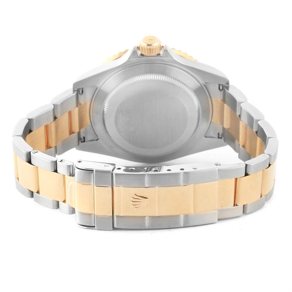 The image shows the back view of a Rolex Submariner 16613 Men's Steel and Gold (two tone) Blue Dial 16613 Men's Steel and Gold (two tone) Blue Dial watch, featuring the case back and two-tone bracelet.