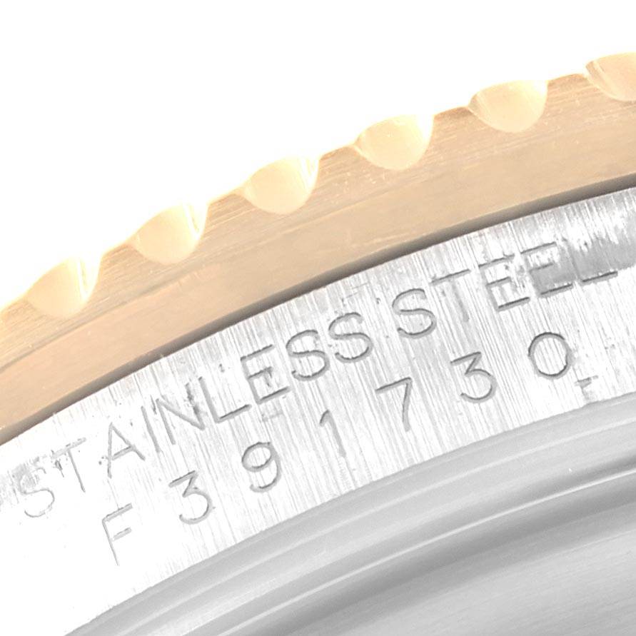 This close-up image shows the stainless steel case and bezel of a Rolex Submariner 16613 Men's Steel and Gold (two tone) Blue Dial 16613 Men's Steel and Gold (two tone) Blue Dial watch, highlighting the engraved serial number.