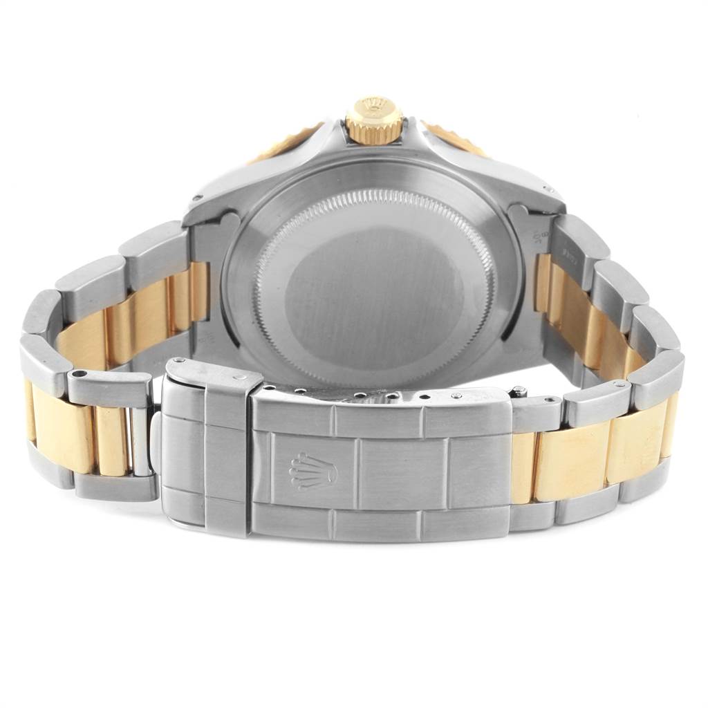 This image shows the back view of a Rolex Submariner 16613 Men's Steel and Gold (two tone) Blue Dial 16613 Men's Steel and Gold (two tone) Blue Dial watch, highlighting its case, caseback, and two-tone bracelet with the clasp.