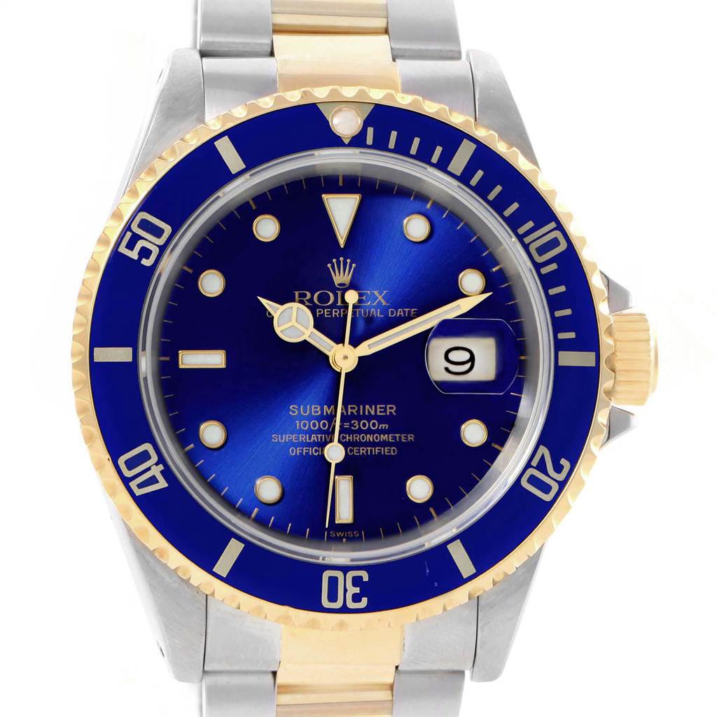 This image shows a close-up of the Rolex Submariner 16613 Men's Steel and Gold (two tone) Blue Dial 16613 Men's Steel and Gold (two tone) Blue Dial watch face, bezel, and part of the bracelet.