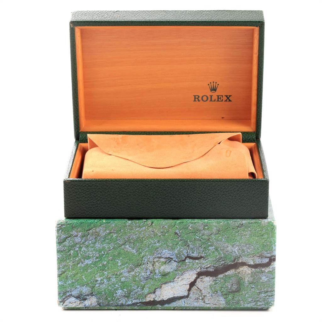 The image shows a green Rolex box with an open top, revealing a tan Rolex pouch inside for a Submariner model watch.