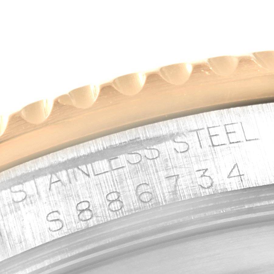 This image shows a close-up of the bezel and part of the engraved case of a Rolex Submariner 16613 Men's Steel and Gold (two tone) Blue Dial 16613 Men's Steel and Gold (two tone) Blue Dial watch.