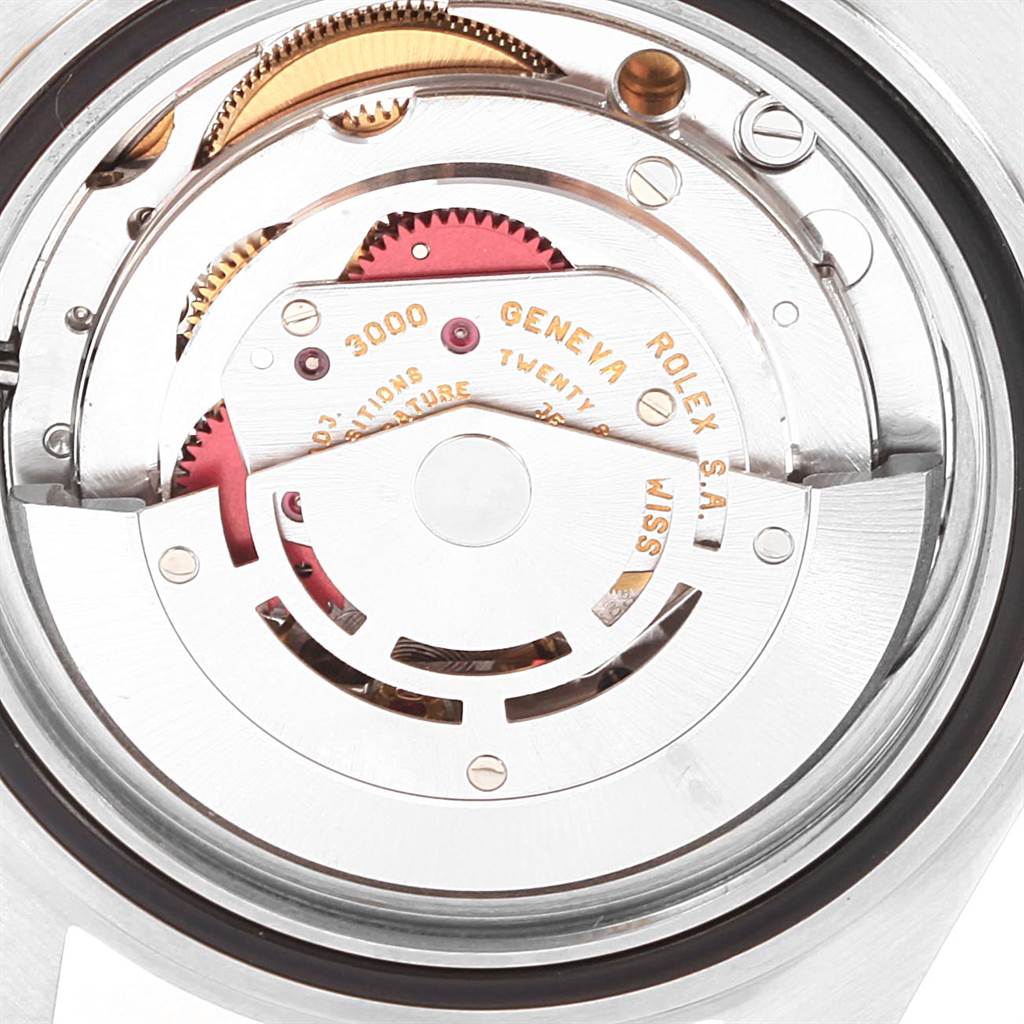 This image shows the internal mechanism of a Rolex Submariner 14060 Men's Stainless Steel Black Dial 14060 Men's Stainless Steel Black Dial watch from an overhead angle, highlighting its gears and movement parts.