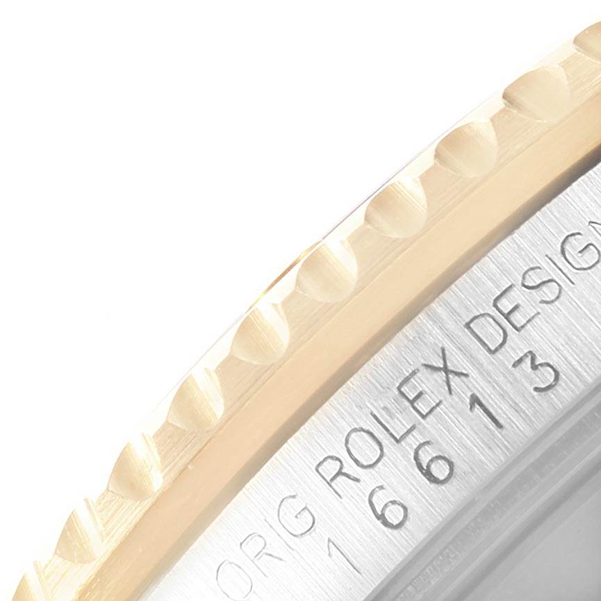 The image shows a close-up angled view of the bezel and engraved edge of the Rolex Submariner 16613 Men's Steel and Gold (two tone) Black Dial 16613 Men's Steel and Gold (two tone) Black Dial.