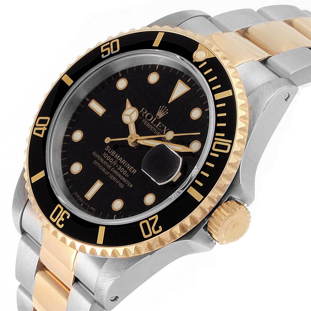 The image shows a Rolex Submariner 16613 Men's Steel and Gold (two tone) Black Dial 16613 Men's Steel and Gold (two tone) Black Dial watch at an angled close-up, highlighting its bezel, dial, crown, and part of the bracelet.