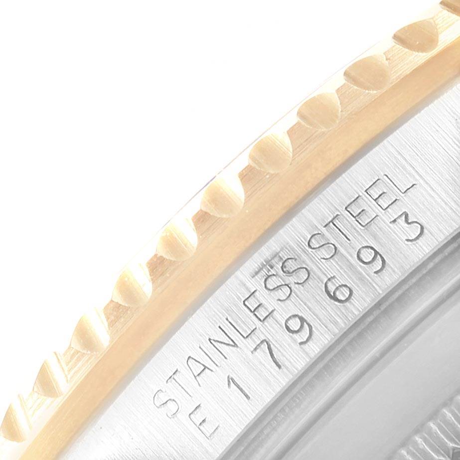 This close-up image shows the engraved model number and the edge of the bezel of a Rolex Submariner 16613 Men's Steel and Gold (two tone) Black Dial 16613 Men's Steel and Gold (two tone) Black Dial watch.