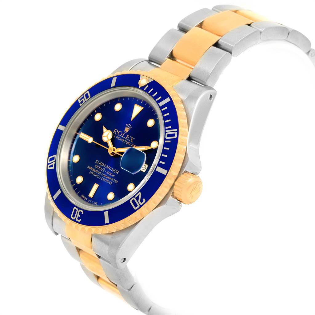 The image shows a Rolex Submariner 16613 Men's Steel and Gold (two tone) Blue Dial 16613 Men's Steel and Gold (two tone) Blue Dial watch at a three-quarter angle, displaying its blue dial, bezel, and two-tone bracelet.