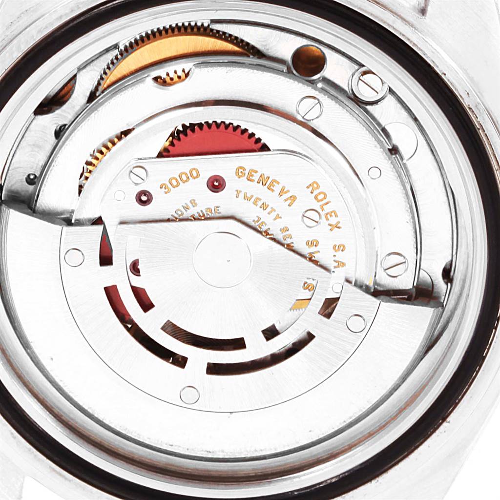 This is a close-up view of the movement inside a Rolex Submariner 14060 Men's Stainless Steel Black Dial 14060 Men's Stainless Steel Black Dial watch, showing gears and internal components.