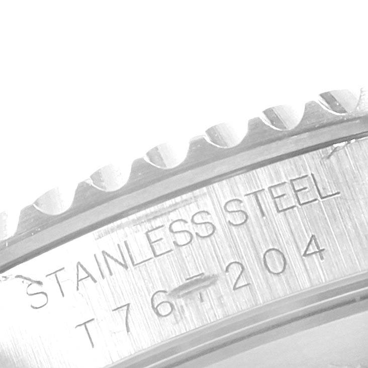 This close-up angle shows the engraved stainless steel part of a Rolex Submariner 14060 Men's Stainless Steel Black Dial 14060 Men's Stainless Steel Black Dial watch.