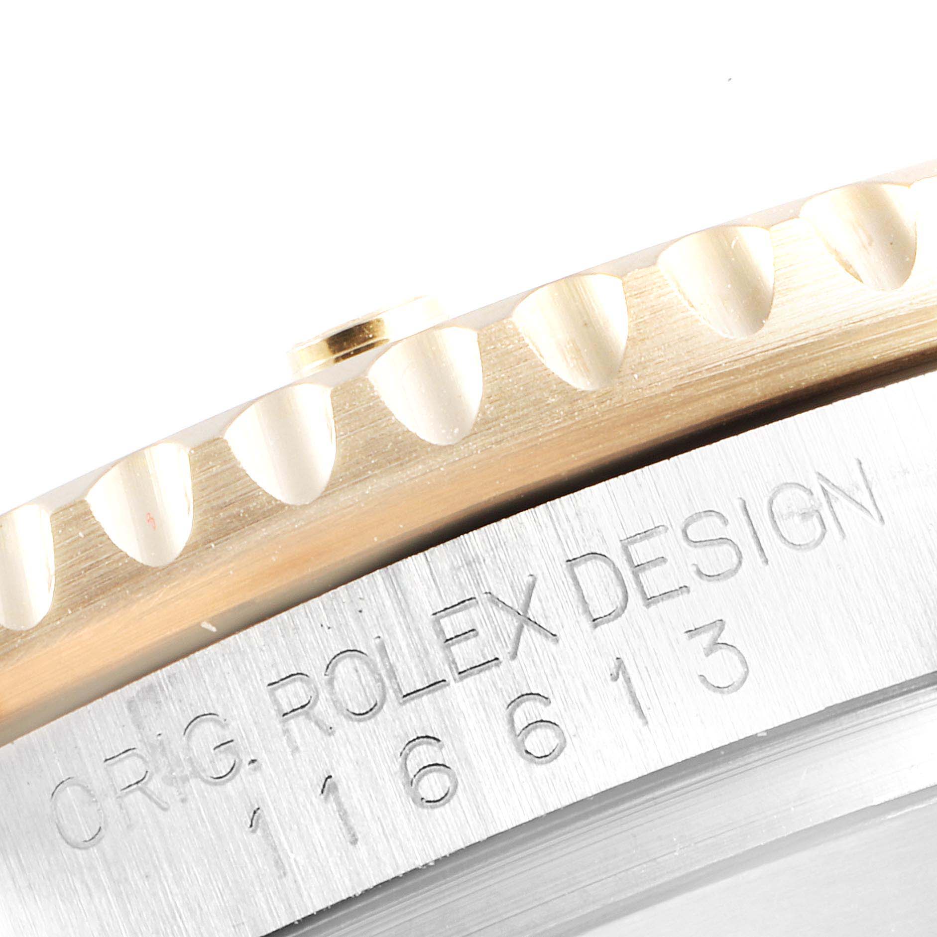 This image shows a close-up of the bezel and case side of a Rolex Submariner 116613 Men's Steel and Gold (two tone) Blue Dial 116613 Men's Steel and Gold (two tone) Blue Dial, including part of the model number engraving.