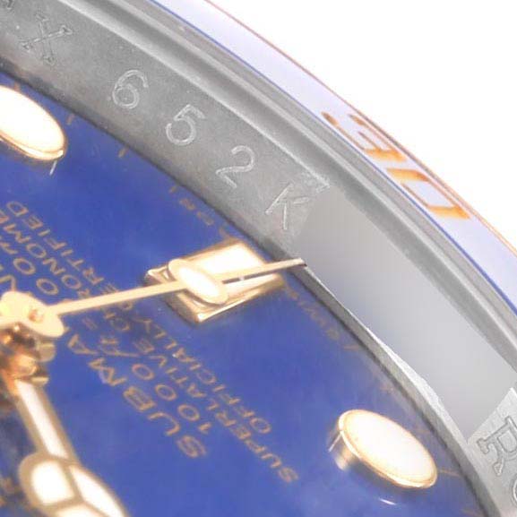 This close-up shot shows the dial, hands, and rehaut engraving of a Rolex Submariner 116613 Men's Steel and Gold (two tone) Blue Dial 116613 Men's Steel and Gold (two tone) Blue Dial watch.