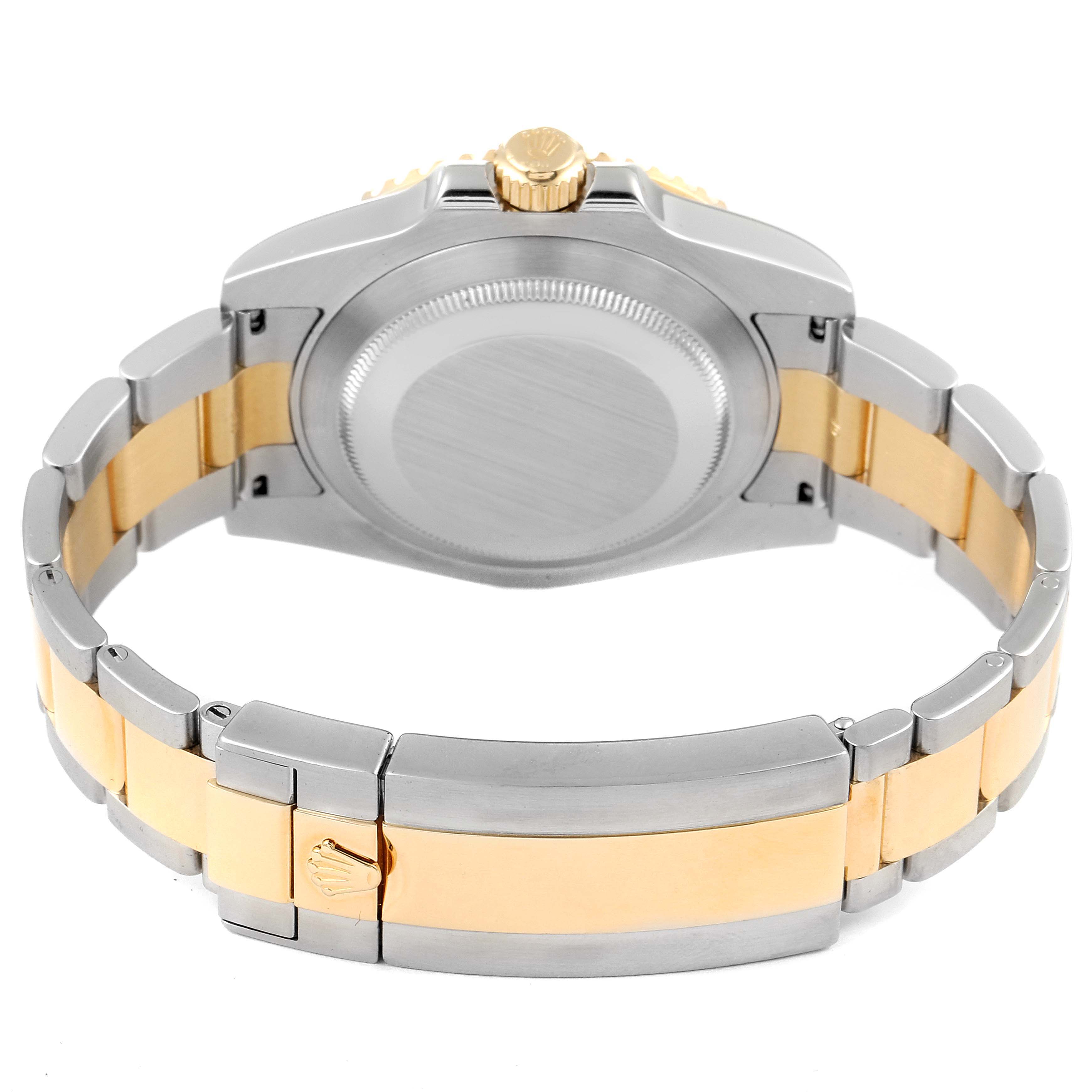 The image shows the back view of a Rolex Submariner 116613 Men's Steel and Gold (two tone) Blue Dial 116613 Men's Steel and Gold (two tone) Blue Dial watch, including its case back, crown, and two-tone bracelet with the clasp.