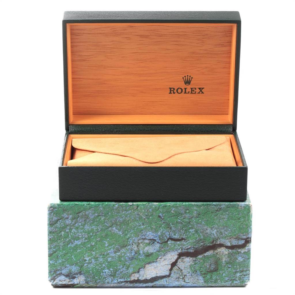 This image shows an open Rolex Submariner 16613 Men's Steel and Gold (two tone) Black Dial 16613 Men's Steel and Gold (two tone) Black Dial watch box, with an inner orange-brown compartment and a partly visible green exterior.