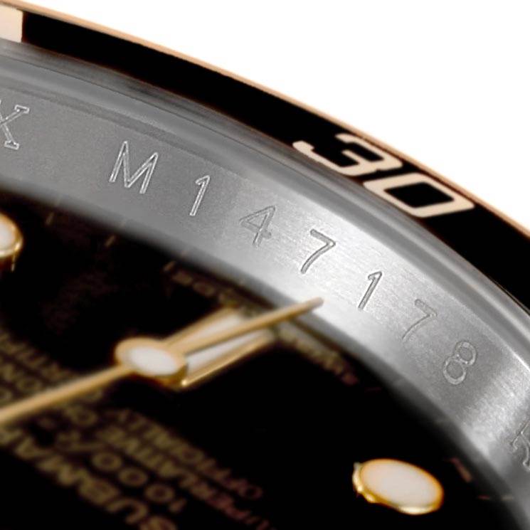 The image shows a close-up of the dial and bezel of a Rolex Submariner 16613 Men's Steel and Gold (two tone) Black Dial 16613 Men's Steel and Gold (two tone) Black Dial watch, focusing on the numbers and hands.