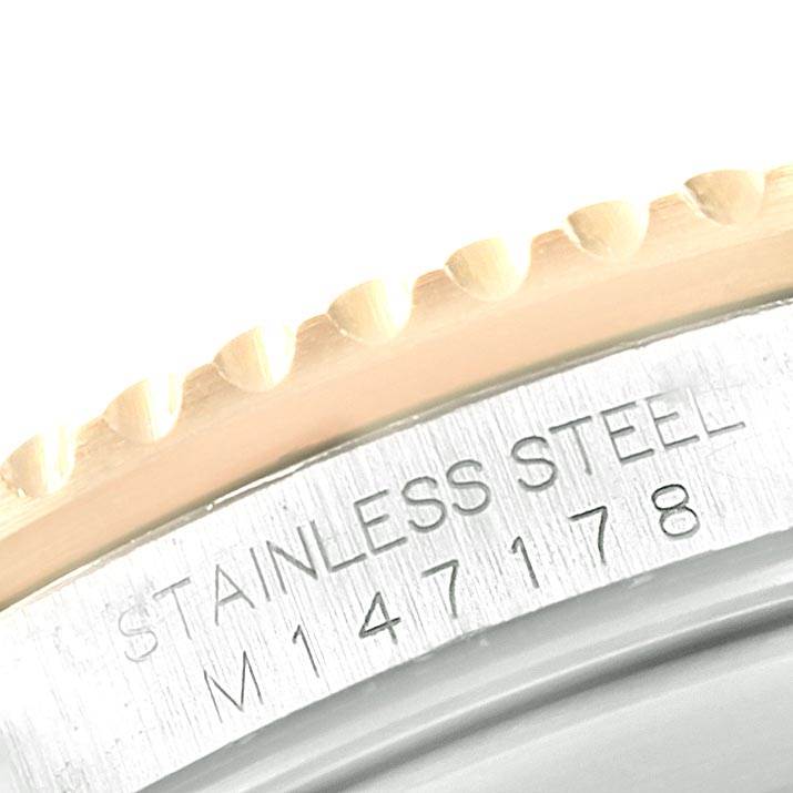 The image shows a close-up of the bezel and stainless steel casing of a Rolex Submariner 16613 Men's Steel and Gold (two tone) Black Dial 16613 Men's Steel and Gold (two tone) Black Dial watch.