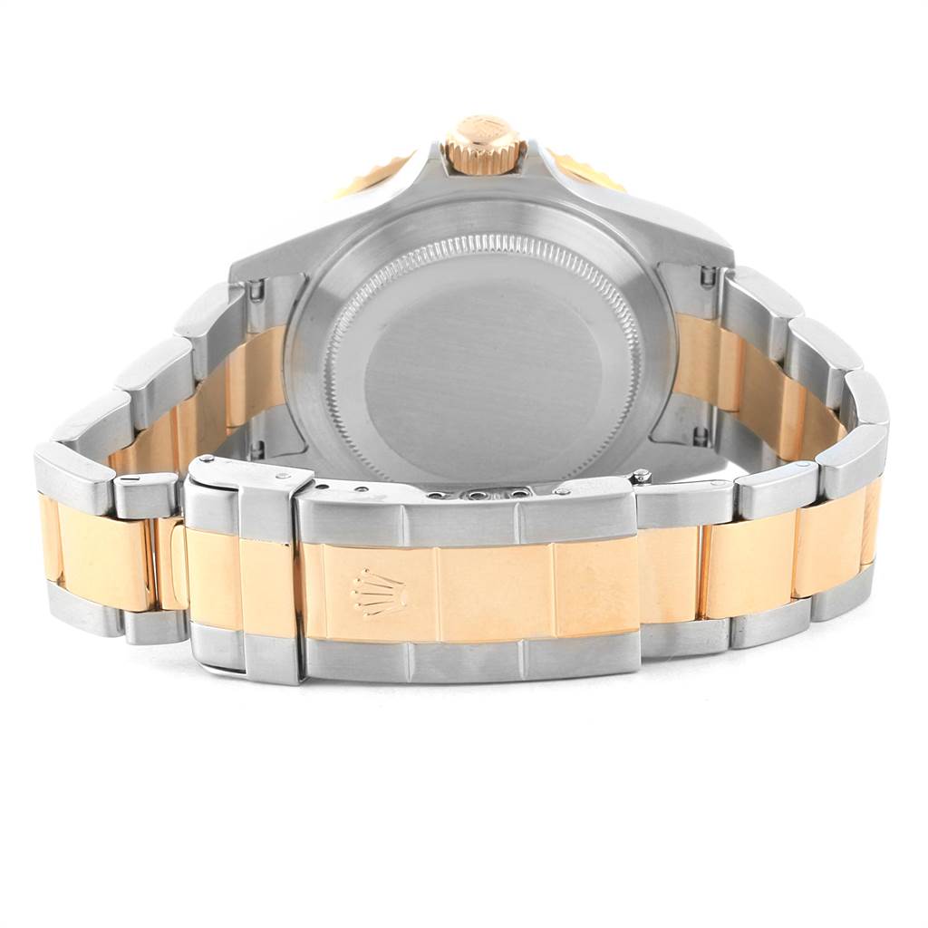 This image shows the back view of a Rolex Submariner 16613 Men's Steel and Gold (two tone) Black Dial 16613 Men's Steel and Gold (two tone) Black Dial, displaying its case back, crown, and two-tone bracelet.