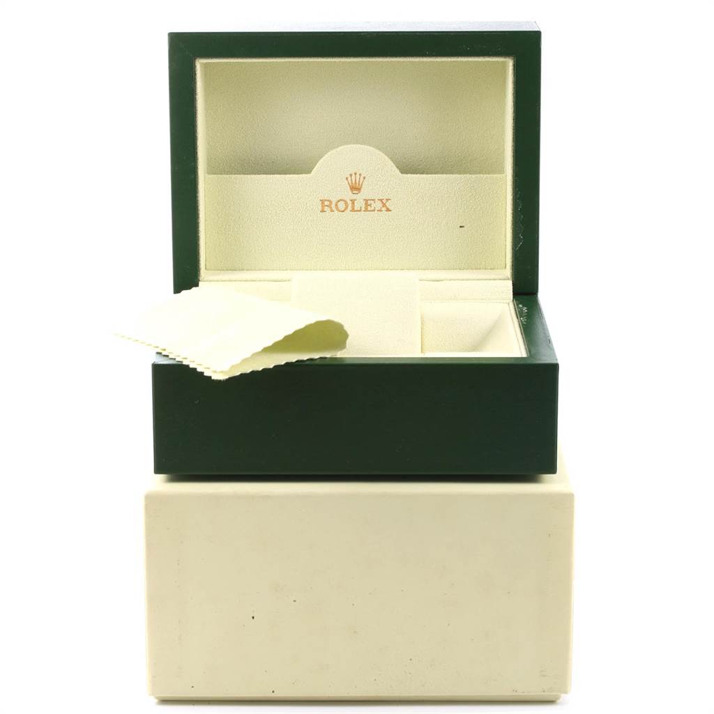 An open Rolex watch box for the Submariner model is shown, with an interior cushion and a cleaning cloth.