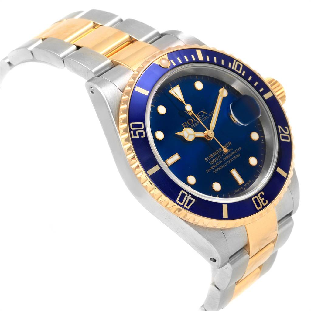 This image shows a Rolex Submariner 16613 Men's Steel and Gold (two tone) Blue Dial 16613 Men's Steel and Gold (two tone) Blue Dial watch at an angle highlighting its blue dial, bezel, and two-tone bracelet.