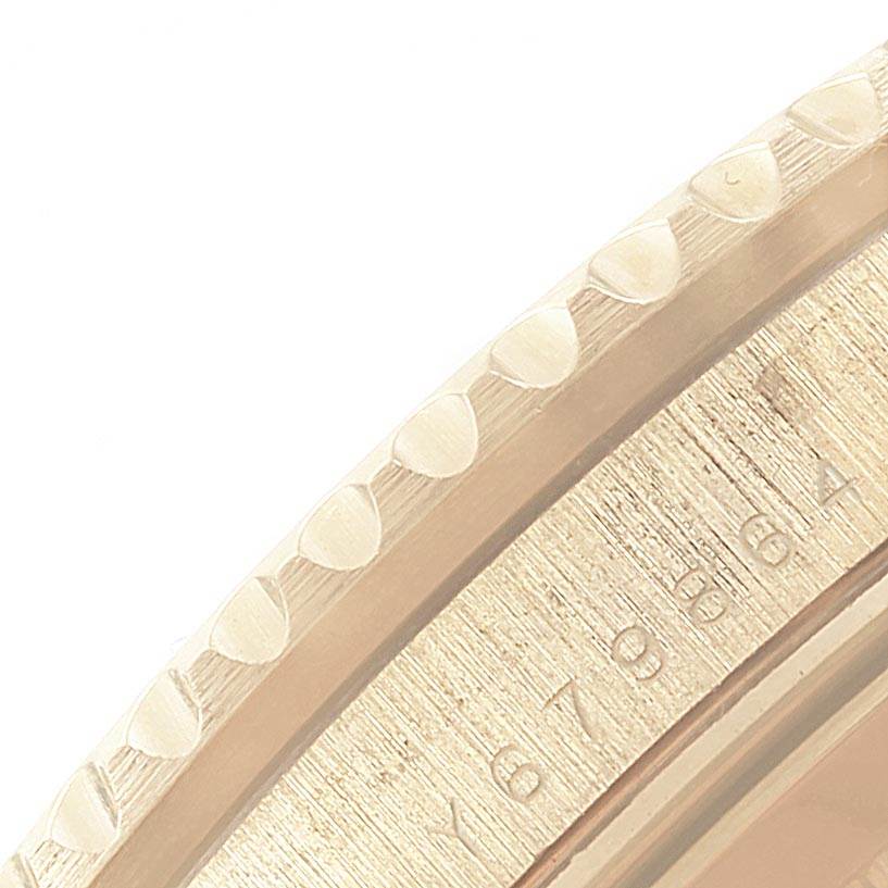 This image shows a close-up of the bezel and edge of the dial of a Rolex Submariner 16618 Men
s Yellow Gold Black Dial 16618 Men
s Yellow Gold Black Dial watch.