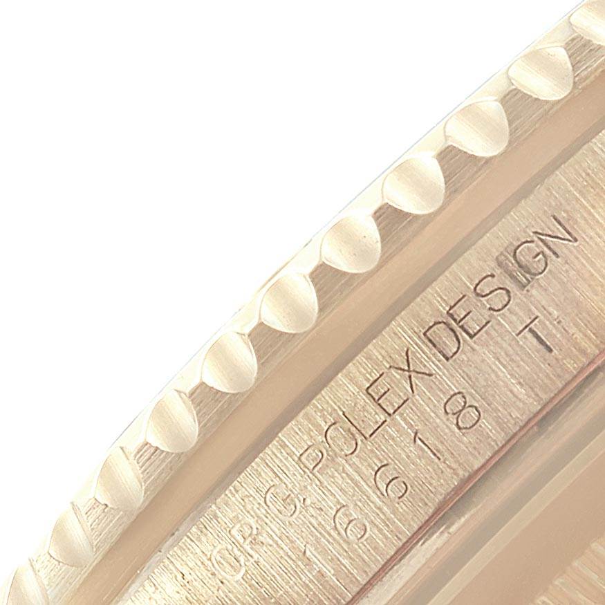 This image shows a close-up of the edge and engraved inner bezel of a Rolex Submariner 16618 Men
s Yellow Gold Black Dial 16618 Men
s Yellow Gold Black Dial watch.