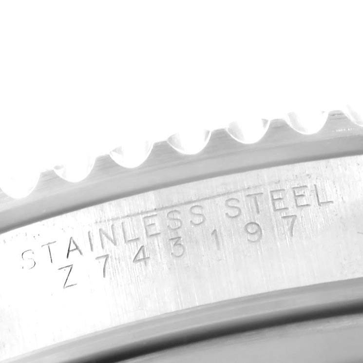 The image shows a close-up of the serial number and "STAINLESS STEEL" engraving on the casing of a Rolex Submariner 14060 Men
s Stainless Steel Black Dial 14060 Men
s Stainless Steel Black Dial watch.