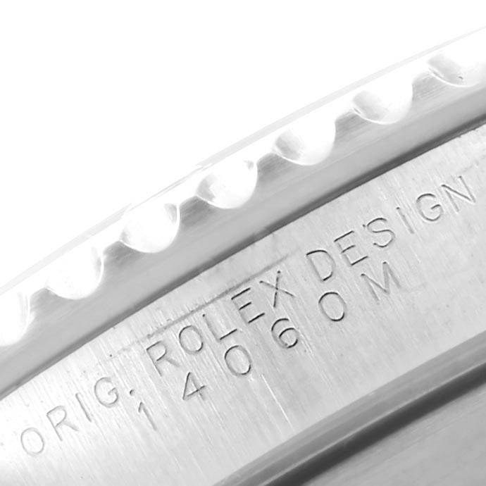 This image shows a close-up of the engraved case side of a Rolex Submariner 14060 Men
s Stainless Steel Black Dial 14060 Men
s Stainless Steel Black Dial watch, displaying "Rolex Design" and model number 14060M.