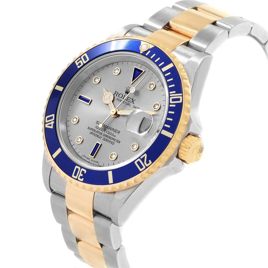 The image shows a Rolex Submariner 16613 Men
s Steel and Gold (two tone) Grey Dial 16613 Men
s Steel and Gold (two tone) Grey Dial watch at a slight angle, highlighting its dial, bezel, crown, and two-tone bracelet.