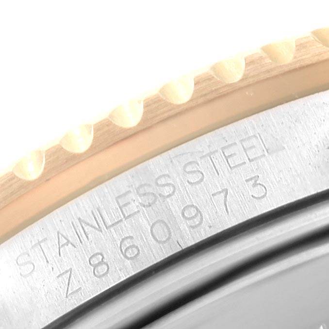 This image shows a close-up of the engraved serial number and "Stainless Steel" text on the side of a Rolex Submariner 16613 Men
s Steel and Gold (two tone) Grey Dial 16613 Men
s Steel and Gold (two tone) Grey Dial watch case.