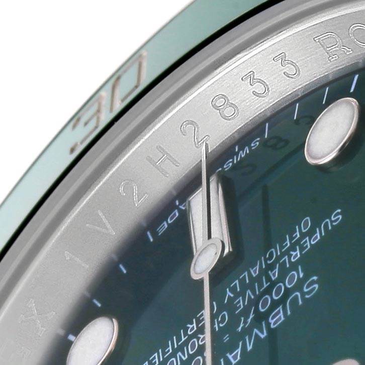 The image shows a close-up angle of the Rolex Submariner 116610LV Men
s Stainless Steel Green Dial 116610LV Men
s Stainless Steel Green Dial dial, hands, and part of the bezel.