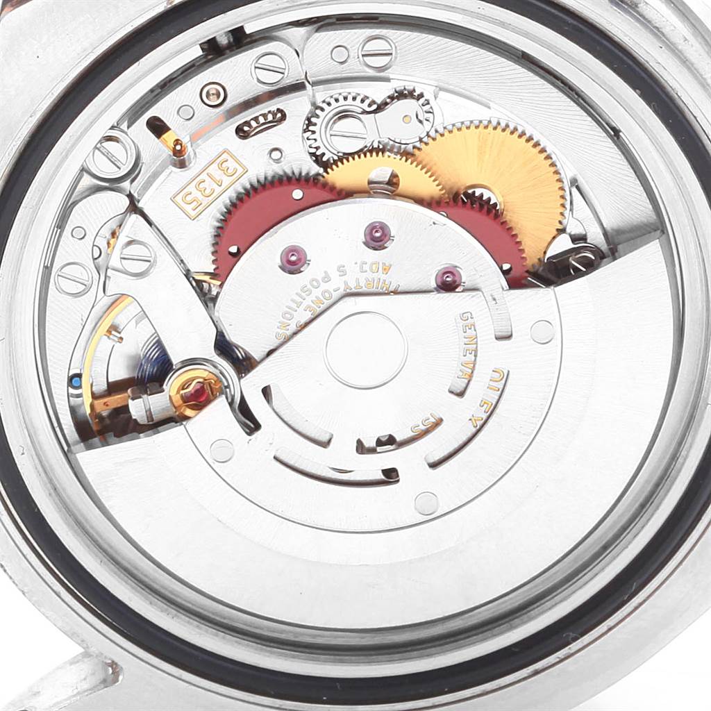 This image shows a close-up of the Rolex Submariner 116610LV Men
s Stainless Steel Green Dial 116610LV Men
s Stainless Steel Green Dial
s movement from the back, highlighting its intricate gears and mechanisms.