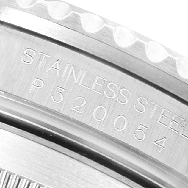 This image shows an angled close-up of the side of a Rolex Submariner 16610 Men
s Stainless Steel Black Dial 16610 Men
s Stainless Steel Black Dial watch, highlighting its stainless steel engraving and serial number.