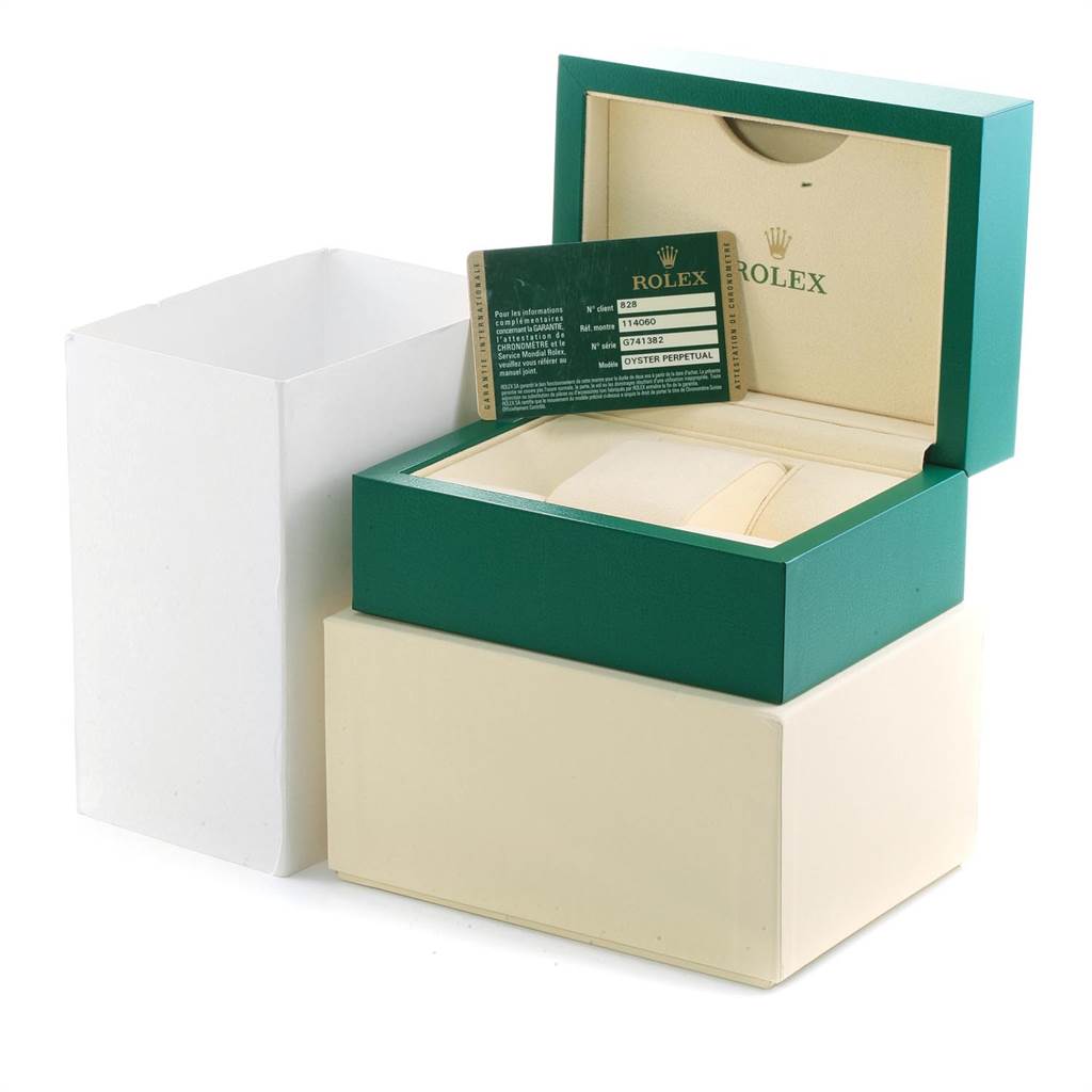 The image shows the packaging box, cushion, and warranty card for a Rolex Submariner 114060 Men
s Stainless Steel Black Dial 114060 Men
s Stainless Steel Black Dial watch.