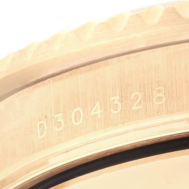 Close-up of the Rolex Submariner 16618 Men
s Yellow Gold Blue Dial 16618 Men
s Yellow Gold Blue Dial model
s gold case, featuring the serial number engraving.